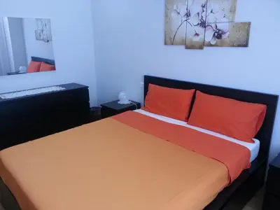 a bedroom with a bed with red and orange pillows at Latere Vatican Loft in Rome