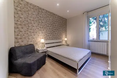 a bedroom with a bed and a chair at Ferrari al Vaticano in Rome