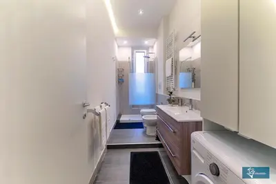 a white bathroom with a toilet and a sink at Ferrari al Vaticano in Rome