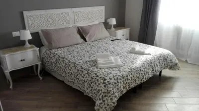 a bedroom with a bed with a black and white bedspread at My Sweet Rome Guest House in Rome