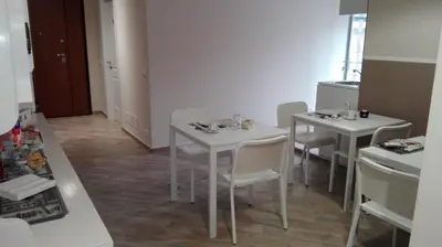 a room with two white tables and white chairs at My Sweet Rome Guest House in Rome