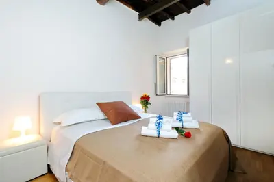 a bedroom with a bed with two towels on it at Pantheon - Argentina Luxury in Rome