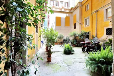 a courtyard with plants and motorcycles in a building at Pantheon - Argentina Luxury in Rome