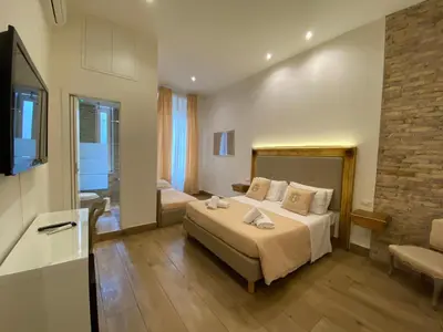 a bedroom with a bed and a couch in a room at Art Atelier Accomodation Guest House in Rome