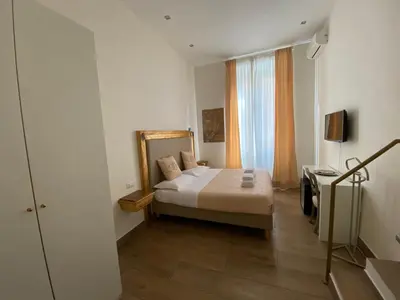 a bedroom with a bed and a desk and a mirror at Art Atelier Accomodation Guest House in Rome