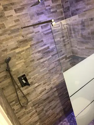 a shower in a bathroom with a glass door at Art Atelier Accomodation Guest House in Rome