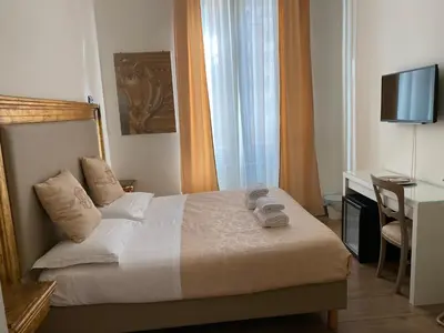 a bedroom with a bed with a desk and a television at Art Atelier Accomodation Guest House in Rome
