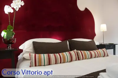 a bathroom with a sink and a toilet and a mirror at Corso Vittorio Apartments in Rome