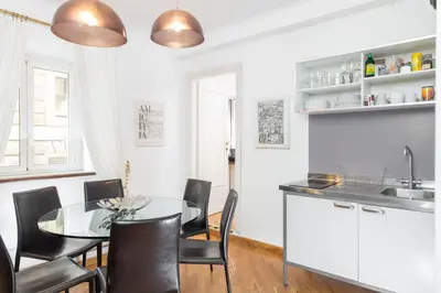 a living room with a table and chairs at Corso Vittorio Apartments in Rome