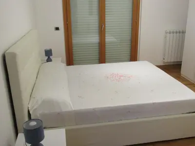 a white bed in a room with a window at Pianeta Roma 45 in Rome