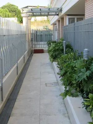 a porch with a fence and some plants at Pianeta Roma 45 in Rome