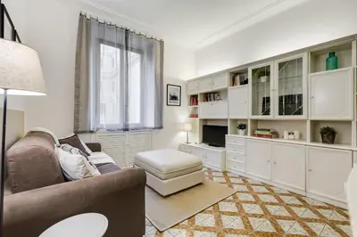 a living room with white cabinets and a couch at Appartamenti con vista Piazza Testaccio in Rome