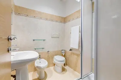 a bathroom with a toilet and a sink and a shower at Appartamenti con vista Piazza Testaccio in Rome