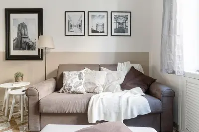a living room with a couch and pictures on the wall at Appartamenti con vista Piazza Testaccio in Rome