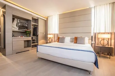 a bedroom with a large white bed in a room at Orazio Palace Hotel in Rome