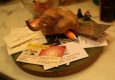 a toy elephant sitting on a plate with some cards at B&B Buongiornoroma in Rome