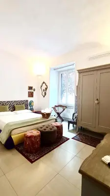 a bedroom with a large bed and a table at Festina Lente in Rome