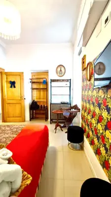 a bedroom with a red bed and a table at Festina Lente in Rome