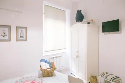a white room with a bed and a window at Festina Lente in Rome