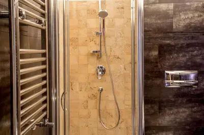 a shower with a hose attached to a wall at Palazzo Medusa in Rome