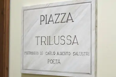 a sign on a wall with the words praia trilova at Domus Corsini in Rome