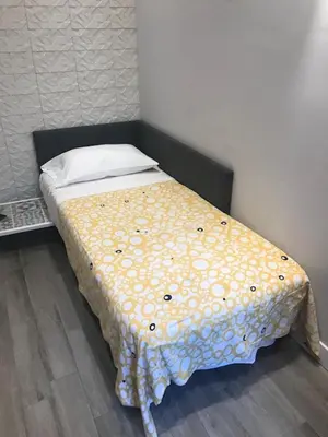 a bed with a polka dot blanket on it at Rome Studio Rental in Rome