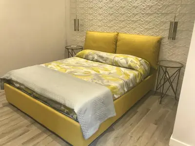 a bed in a room with two tables at Rome Studio Rental in Rome
