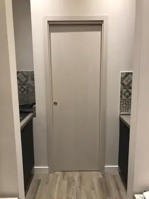 a white door in a room with wooden floors at Rome Studio Rental in Rome