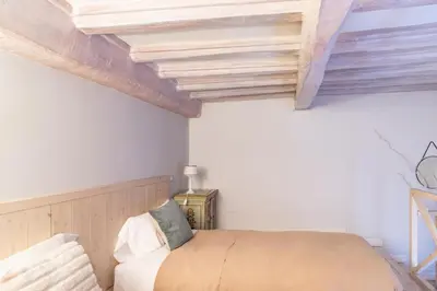 a bedroom with a bed and a wooden ceiling at Monserrato Historical by Campo de' Fiori in Rome