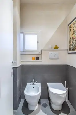 a bathroom with a white toilet and a sink at Monserrato Historical by Campo de' Fiori in Rome