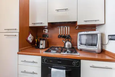 a small kitchen with a stove and a microwave at Rent Home In Rome in Rome