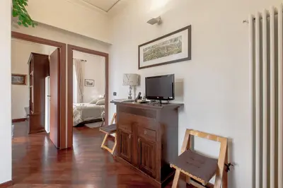 a living room with a television on a wooden dresser at Rent Home In Rome in Rome