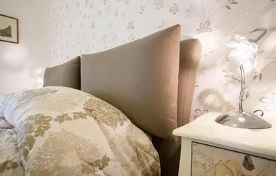 a bedroom with a bed with a pillow and a side table at Rent Home In Rome in Rome