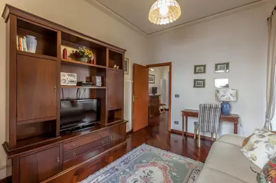 a living room with a large wooden entertainment center at Rent Home In Rome in Rome