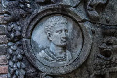 a statue of a bust of a man on a wall at Porta Latina Suite - Private Apartment Rome's Center in Rome