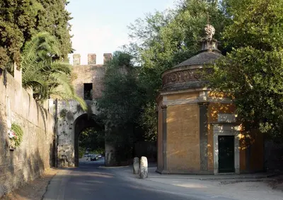 an archway with an old building on the side of a street at Porta Latina Suite - Private Apartment Rome's Center in Rome