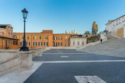 an empty street with stairs and a light pole at Les Diamants in Rome