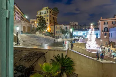a city at night with a christmas tree and stairs at Les Diamants in Rome