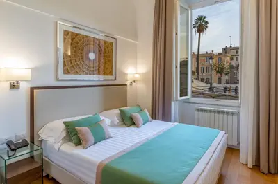 a bedroom with a large bed with a large window at Les Diamants in Rome