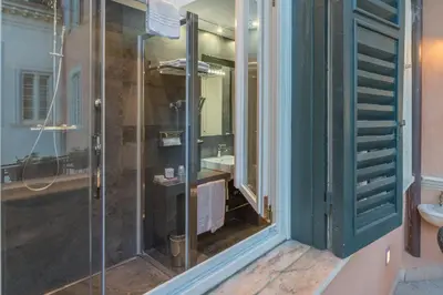 a glass shower in a bathroom with a sink at Les Diamants in Rome