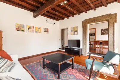 a living room with a table and a couch at Farnese Apartment 1870 in Rome