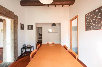 a conference room with a long wooden table and chairs at Farnese Apartment 1870 in Rome