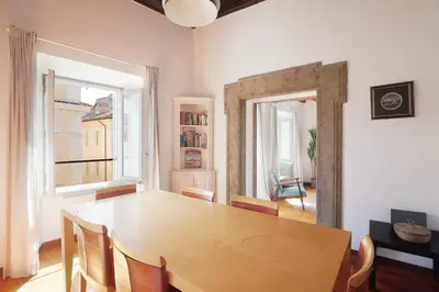 a dining room with a wooden table and chairs at Farnese Apartment 1870 in Rome