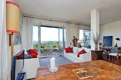 a living room with a couch and a table at Sant'Onofrio Terrace Apartment in Rome