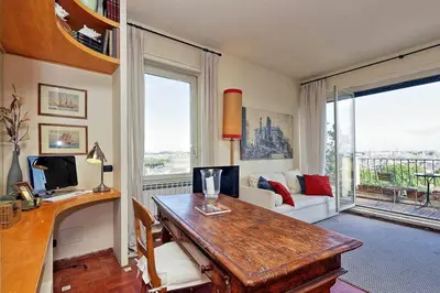 a living room with a desk with a computer on it at Sant'Onofrio Terrace Apartment in Rome