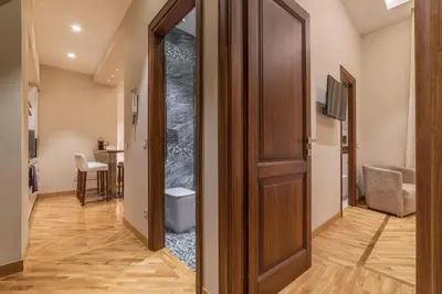 a hallway with a door and a toilet in a room at 900 Apartments Lazio, Emilia & La Corte in Rome