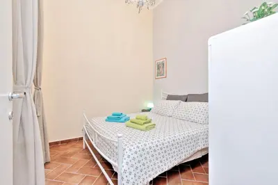 a bedroom with a bed with two towels on it at Le 2 Basiliche - Esquilino Retreat in Rome
