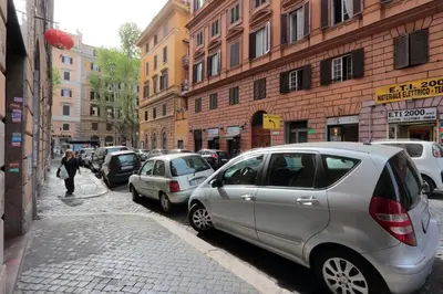 a row of cars parked on a city street at Le 2 Basiliche - Esquilino Retreat in Rome