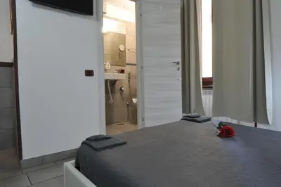 a bedroom with a bed with a red rose on it at Roma sogno infinito in Rome