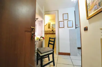 a hallway with a chair next to a door at Roma sogno infinito in Rome